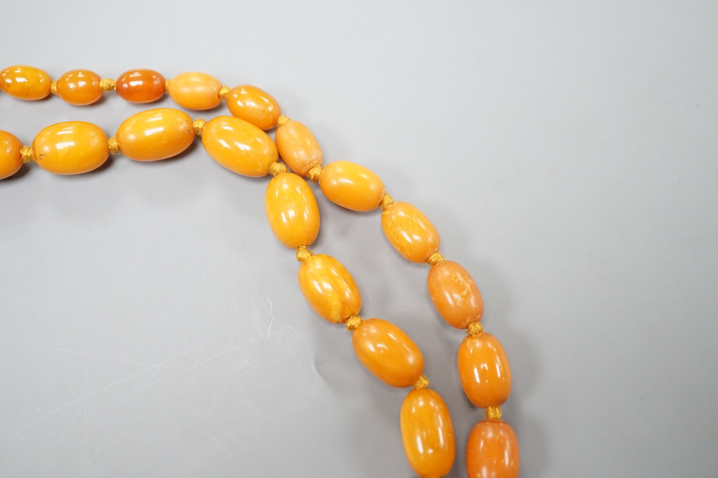 A single strand graduated oval amber bead necklace, 88cm, gross weight 50 grams.